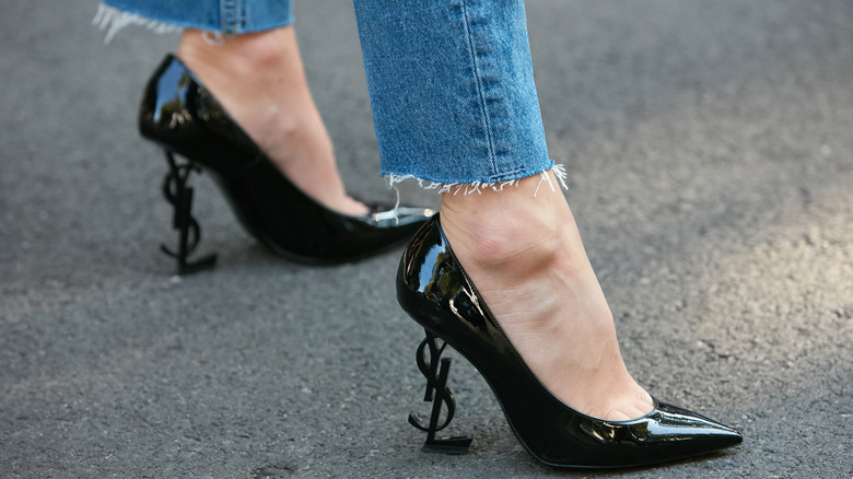 Person wearing black heels, jeans