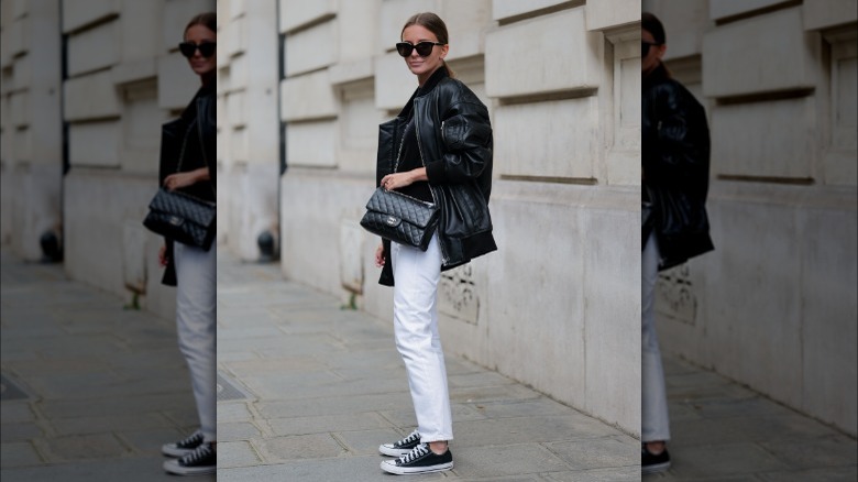 Stylish woman wearing black Converse