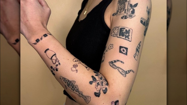 multiple blackwork tattoos on arm