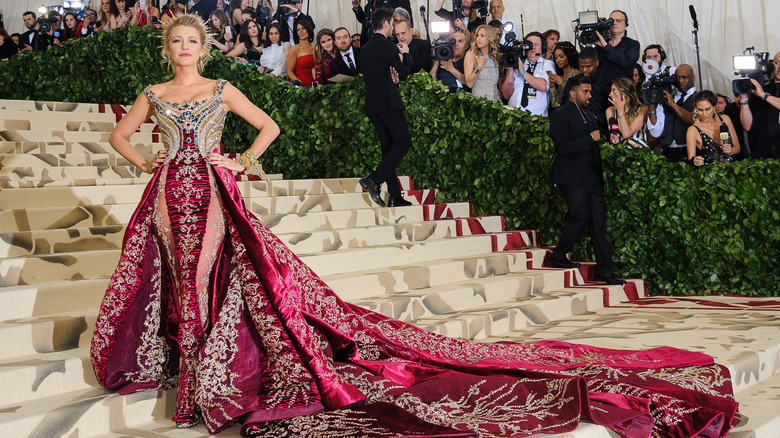 Blake Lively posing on the Met Gala steps in a dramatic gown