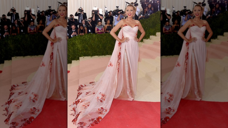 Blake Lively posing on the Met Gala steps in a flowing pink gown