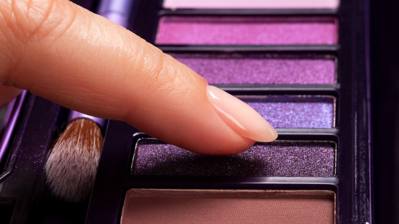 finger in eyeshadow palette