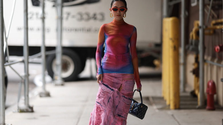 Girl wearing long denim skirt and tie dye top