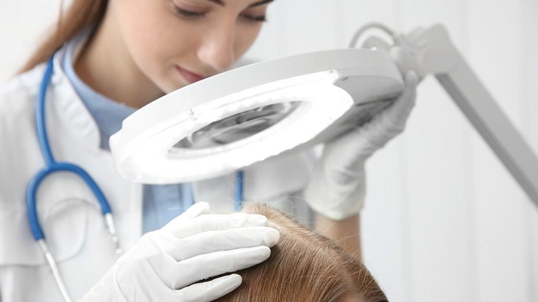 doctor examining scalp