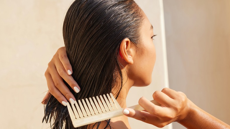 Woman combing wet hair