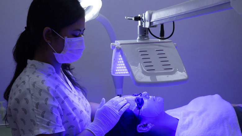 Woman having blue light therapy 