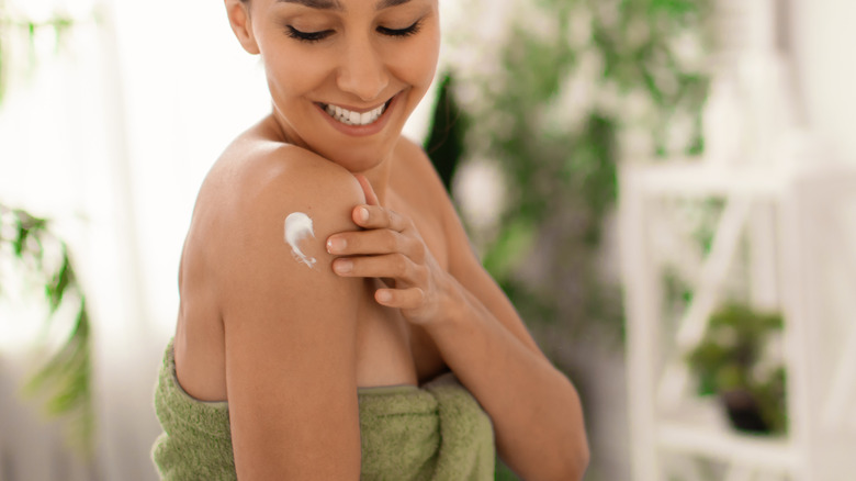 woman applying body cream