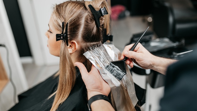 woman getting hair bleached