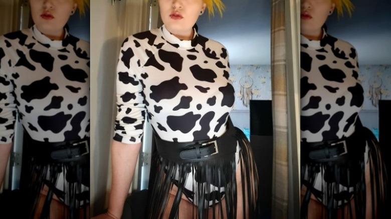 Cow-print bodysuit and black fringe belt