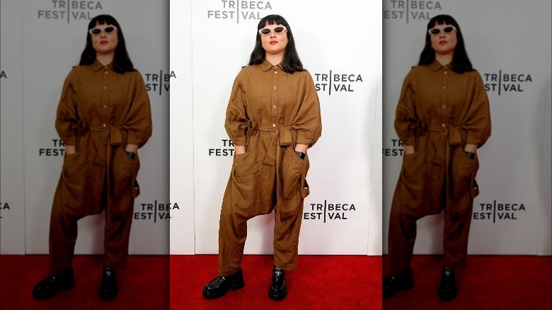 Carolina Costa wears baggy brown boiler suit