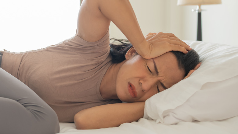 Woman in bed with a hangover