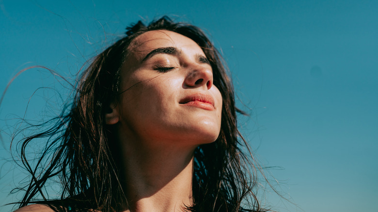 Woman at peace in sun 