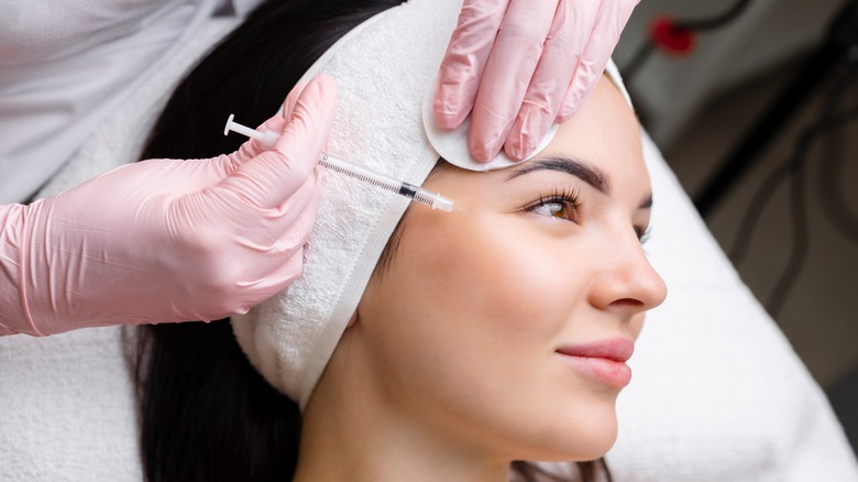 Woman being injected in face