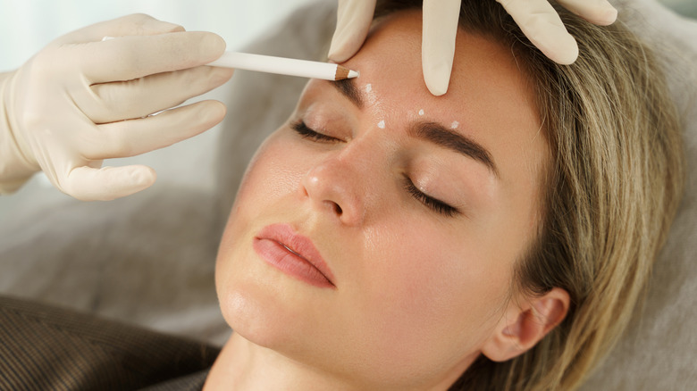 woman getting marked before procedure