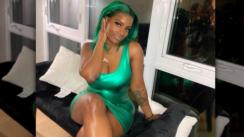 Woman in green dress by Instagram user @therealhairbyqueenbb