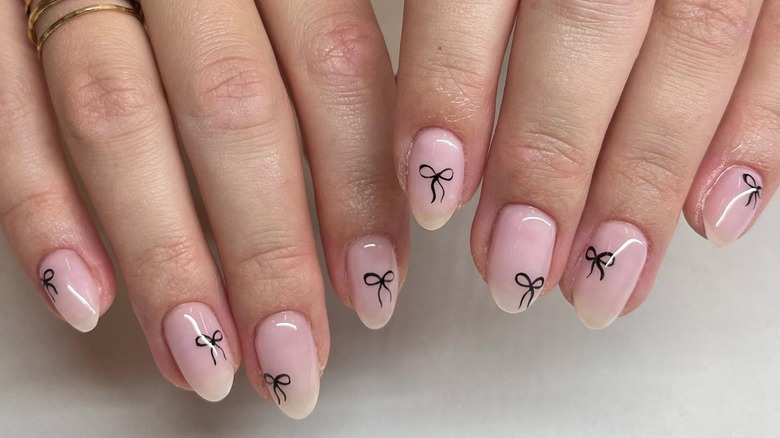 rounded sheer pink nails black bows