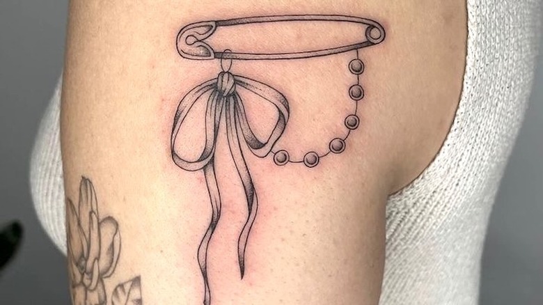 Bow and safety pin tattoo