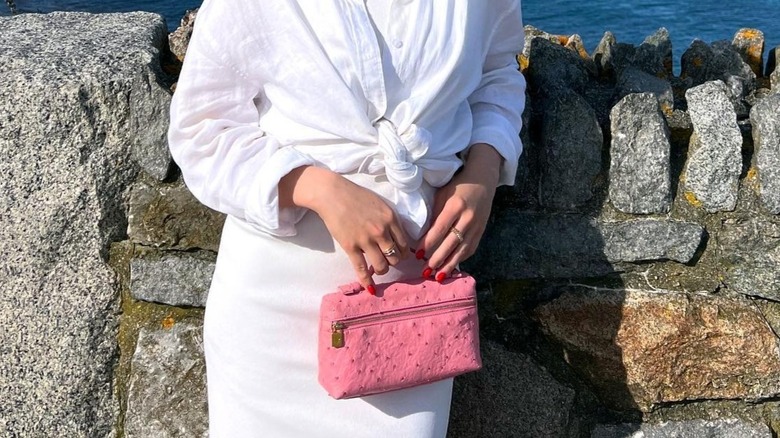Girl carrying a Loro Piana vanity case