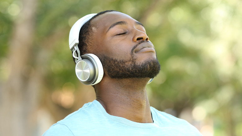 Black man breathing deeply outdoors