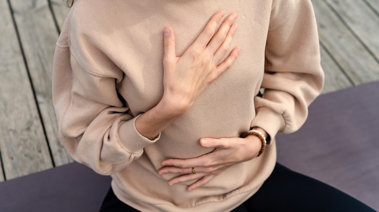 Woman holding herself during a breathing exercise