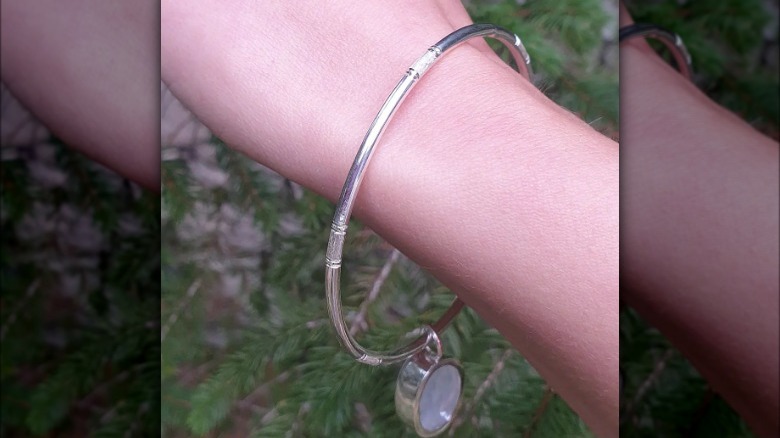 large silver bangle on wrist