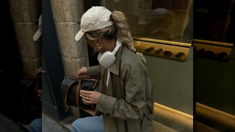 Braided ponytail tucked through baseball cap