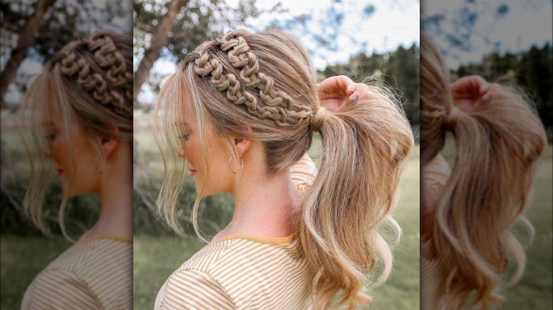 A woman with an accent snake braids and ponytail