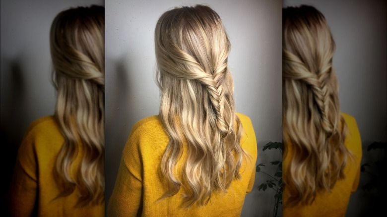 A woman with a half-updo fishtail braid