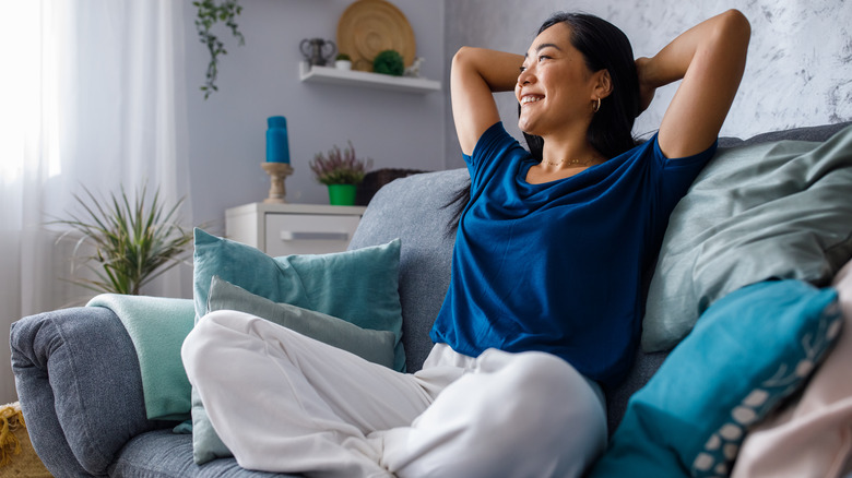 peaceful smiling woman on sofa