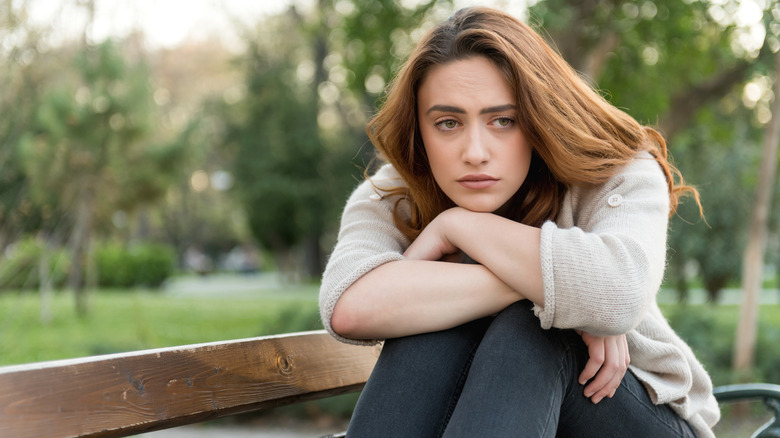 sad woman on park bench