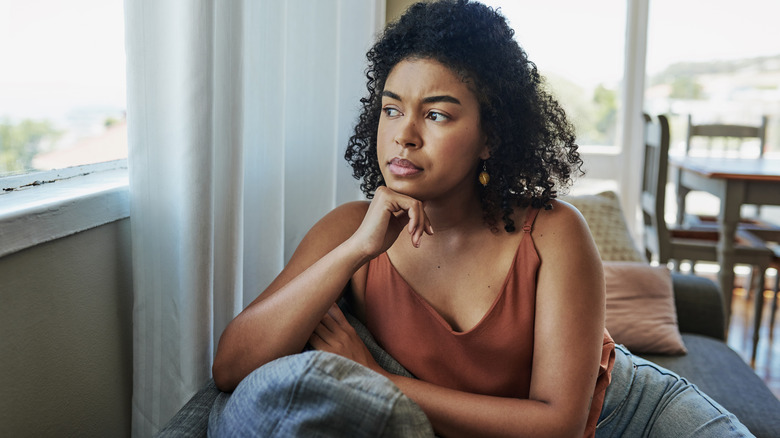 stressed woman looking out window