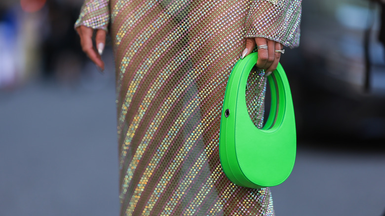 Person carrying bright-green bag