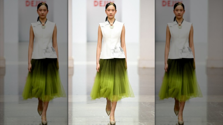 Model wearing tulle green skirt