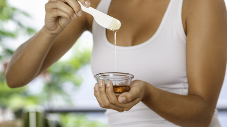 Woman with a bowl of wax.