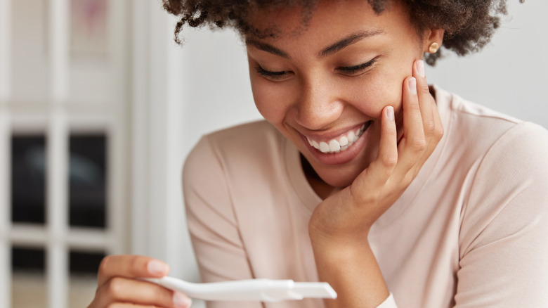 Woman looking at pregnancy test