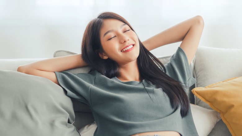 Young woman lounging on couch