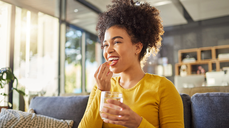 Young woman taking medication