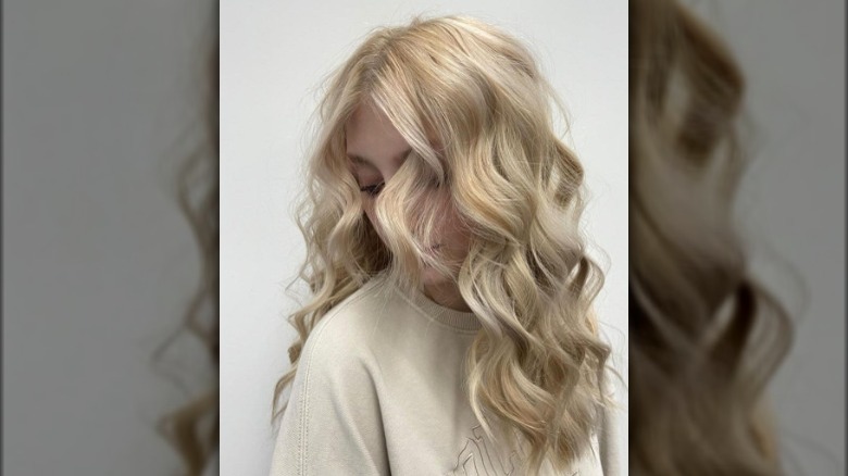 A woman with buttercream blond hair