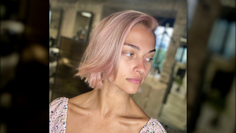 A woman with pastel pink hair