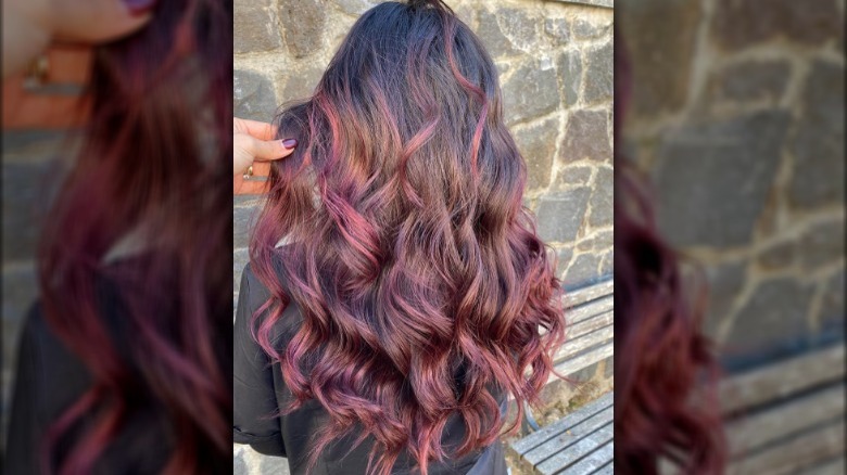 A woman with strawberry balayage on brown hair