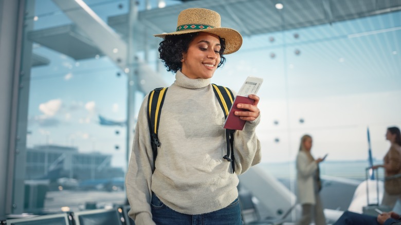 Woman looking at phone in airport