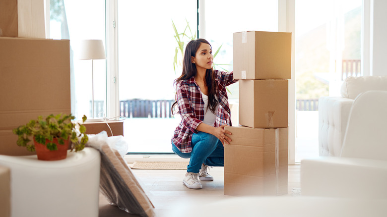 Woman stacking moving boxes