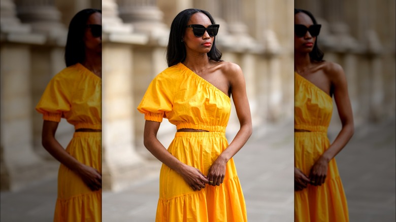 Woman wearing asymmetrical yellow dress