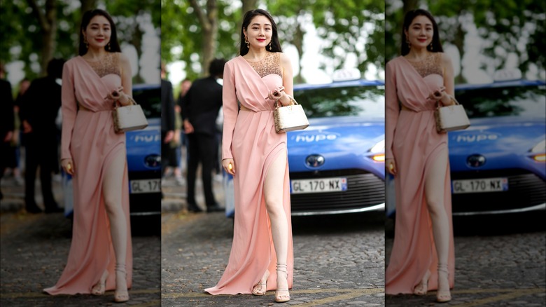 Woman wearing asymmetrical pink dress