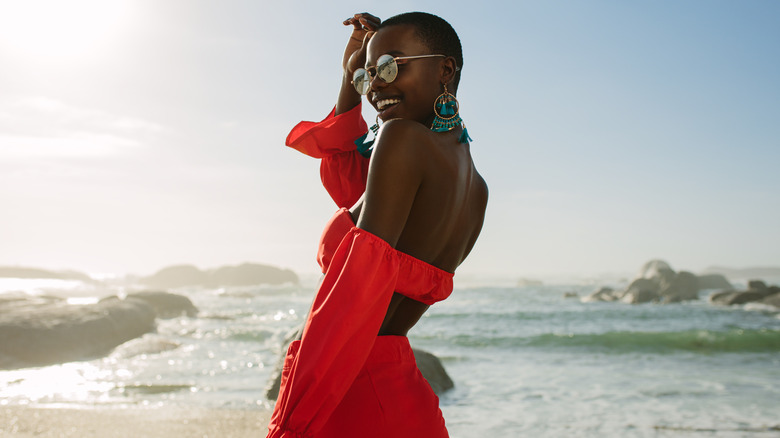 Woman wearing matching red crop top and skirt