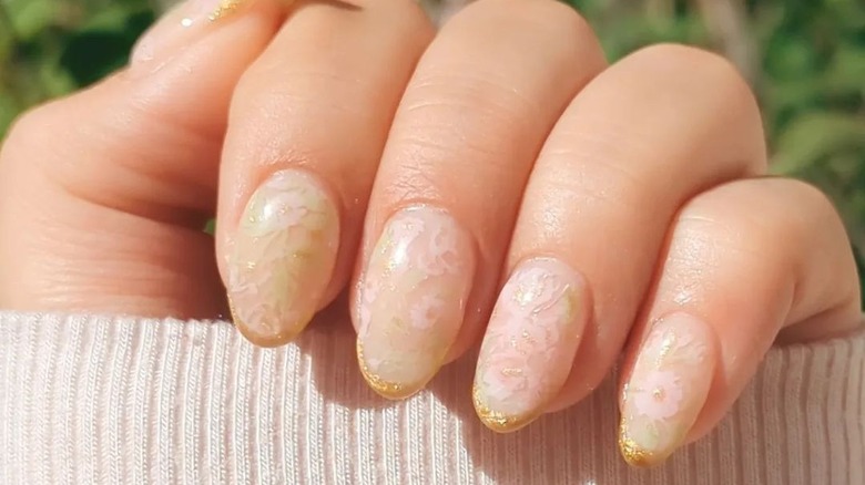 Gold-tipped floral  manicure