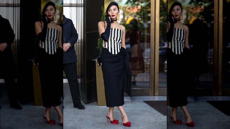 Woman wearing black skirt and red sling-backs