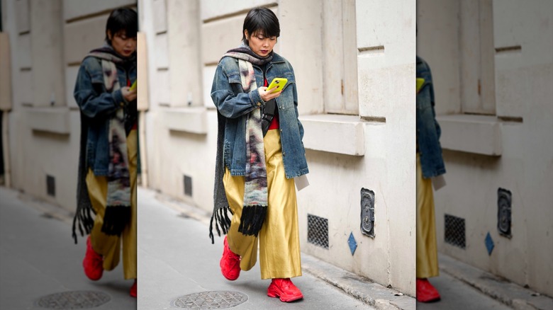 Woman wearing chunky red sneakers