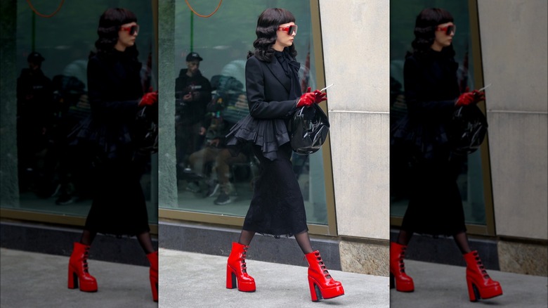 Cara Delevingne wearing red platform heels