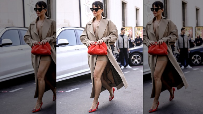 Woman wearing trench coat and red heels